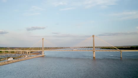 Drone-of-a-suspension-bridge-crossing-the-Mississippi-River-during-sunset