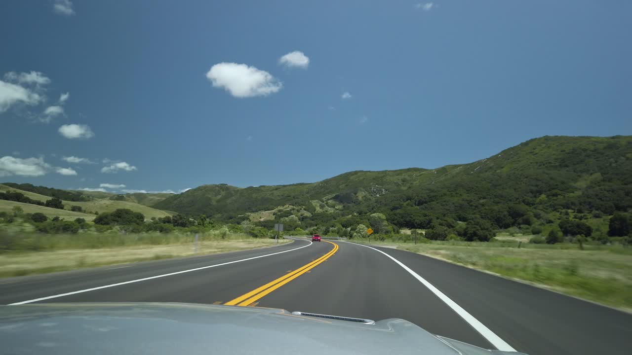 Road Trip Through Scenic Hills and Mountains on a Highway