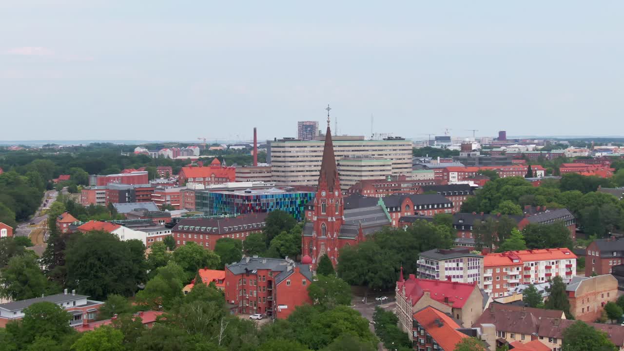 Aerial arc video of central Lund with view of the All Saints Church and Sk&aring;ne University Hospital in the background