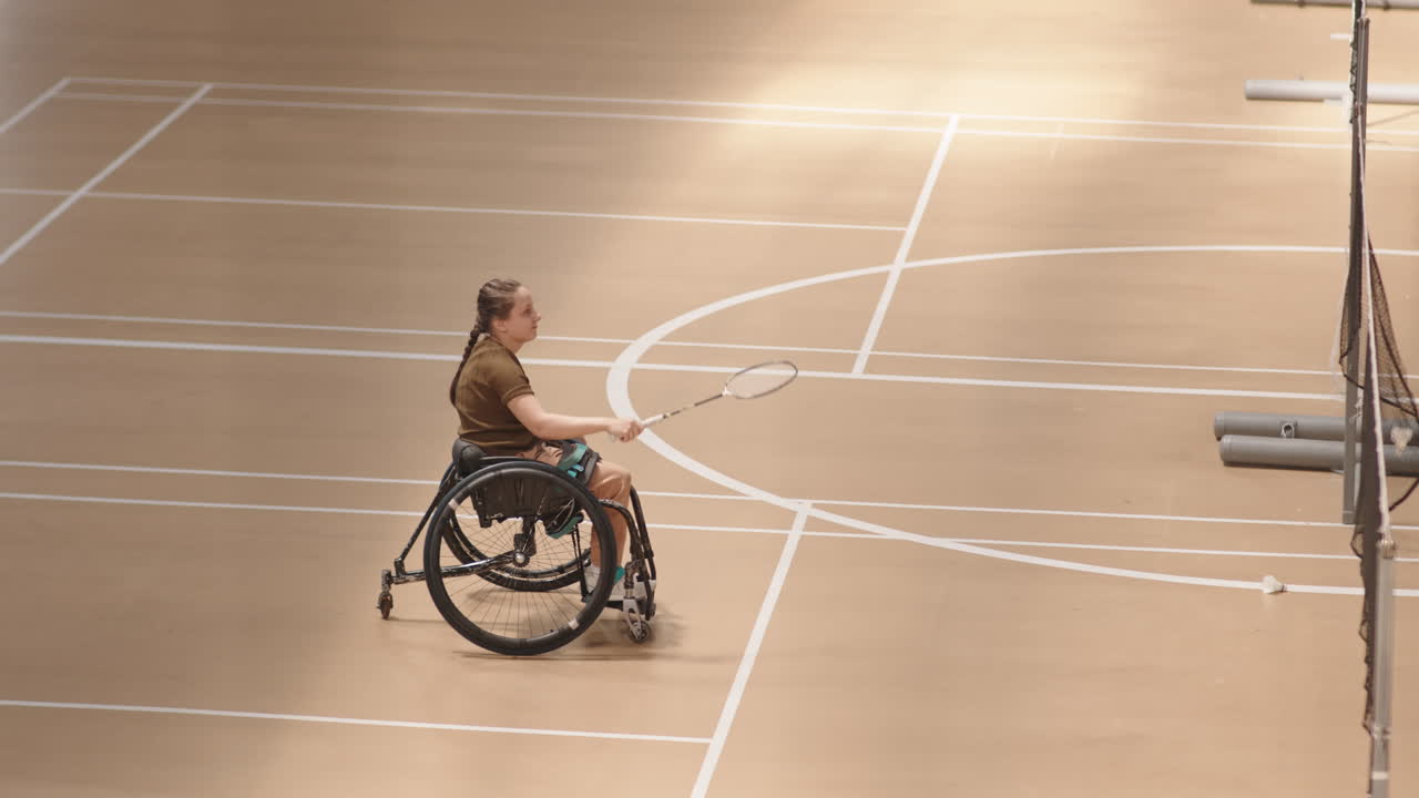 Girl with Disability Playing Badminton Indoors