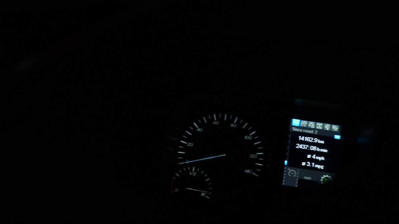 Night shot of a lorry dashboard with lighting on,