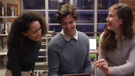 creative businesspeople discussing over digital table in modern office