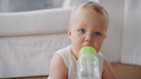 cute baby drinking milk in bottle healthy toddler at home 4k