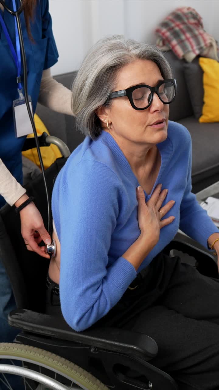 Healthcare Worker Checks Elderly Woman's Lungs with Stethoscope