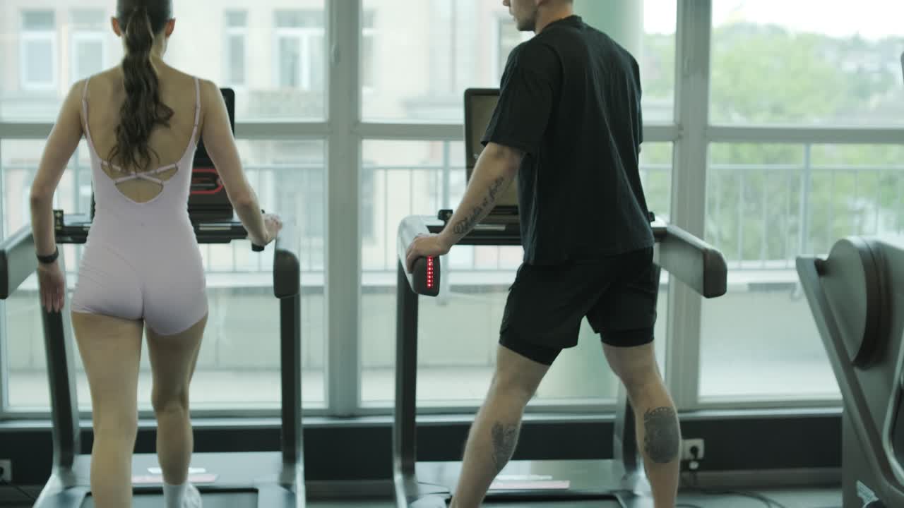 People using treadmills in a gym