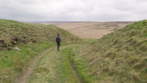 Young-boy-outdoors-on-the-moors-playing-with-his-RC-Car,-Truck,-4-x-4