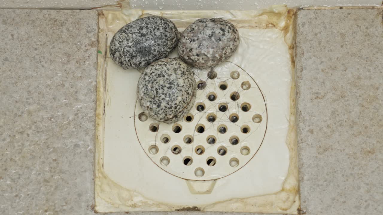 Three Pieces Of Natural Pumice Stones In A Bathroom Drainage
