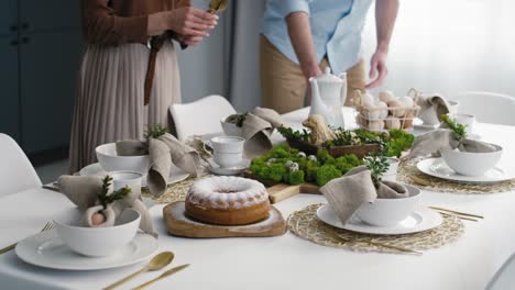 Caucasian-couple-preparing--table-for-easter-dinner.