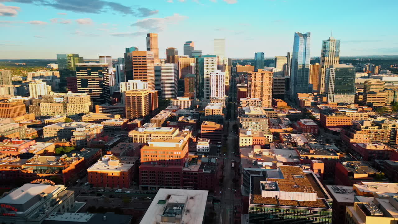 Bright sun dazzles the scenery of modern Denver, Colorado, USA. View on the downtown of the city at sunset time