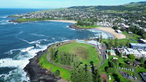 Landscape-view-of-Kiama-tourism-local-sandy-beaches-with-oval-on-hill-coastline-rocky-headland-trees-rural-suburbs-main-town-South-Coast-Australia-travel-tourism