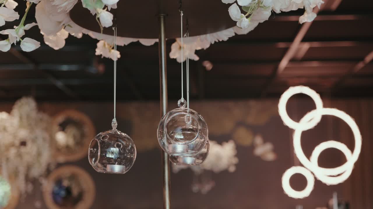 delicate glass orbs with candles float under romantic modern lights