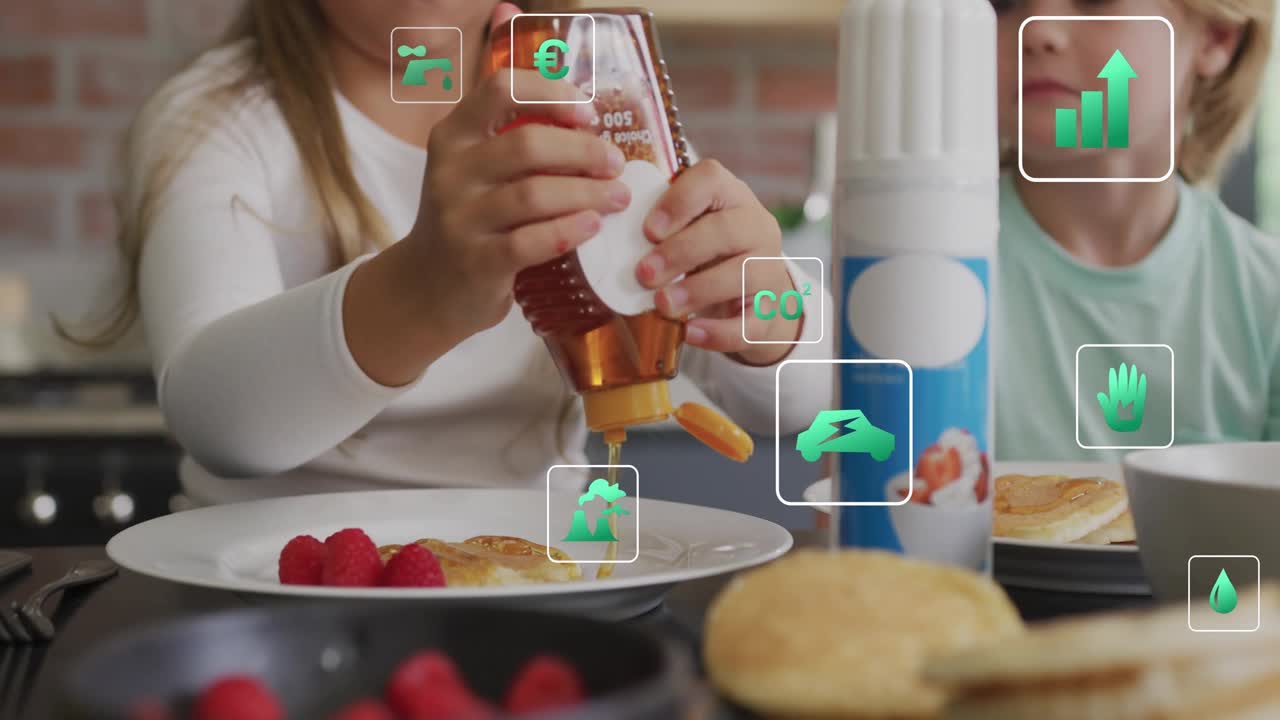 Siblings pouring honey onto pancakes to sweeten breakfast sparking green icons swirling around them