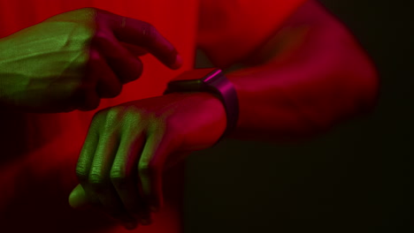 person checking smartwatch in bright lighting