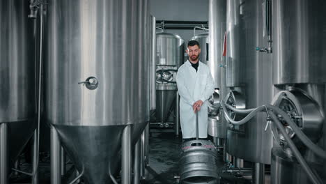 brewery worker in a stainless steel tank room