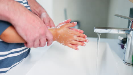 Parents,-kid-and-washing-hands-in-bathroom