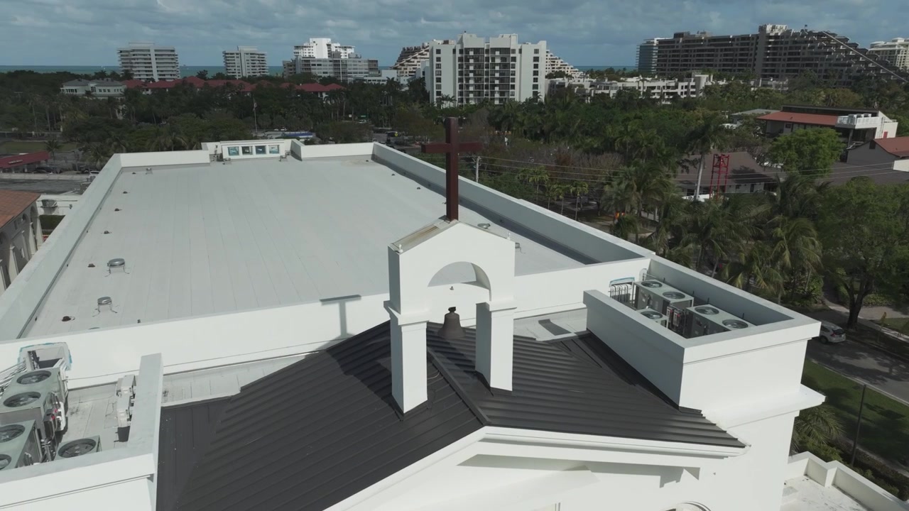 Close-up aerial shot of the steeple on top of the St. Agnes Catholic Church in Key Biscayne, FL.