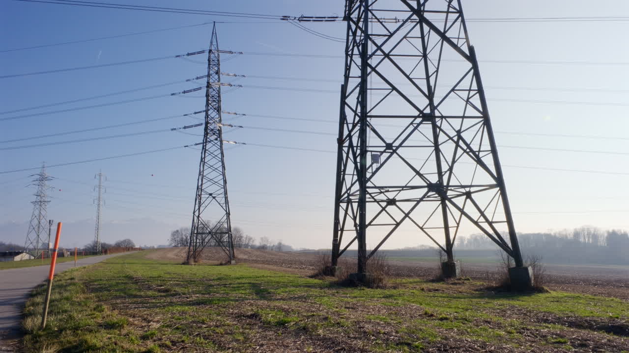 Twin poles towering rural lands of France at daytime
