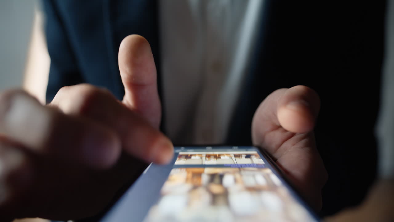 Fingers swiping phone screen in macro view scrolling online conversation closeup