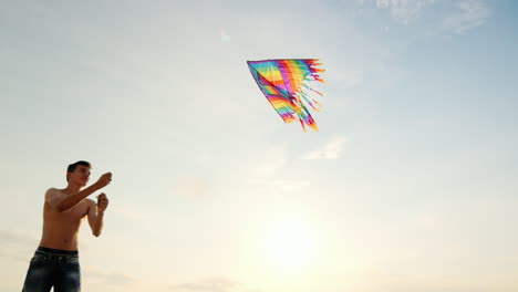 Boy-Teenager-Playing-With-A-Kite-Against-The-Background-Of-Blue-Sky-View-From-Below