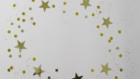 Video-of-gold-and-silver-star-and-circle-confetti-on-white-background-with-central-copy-space