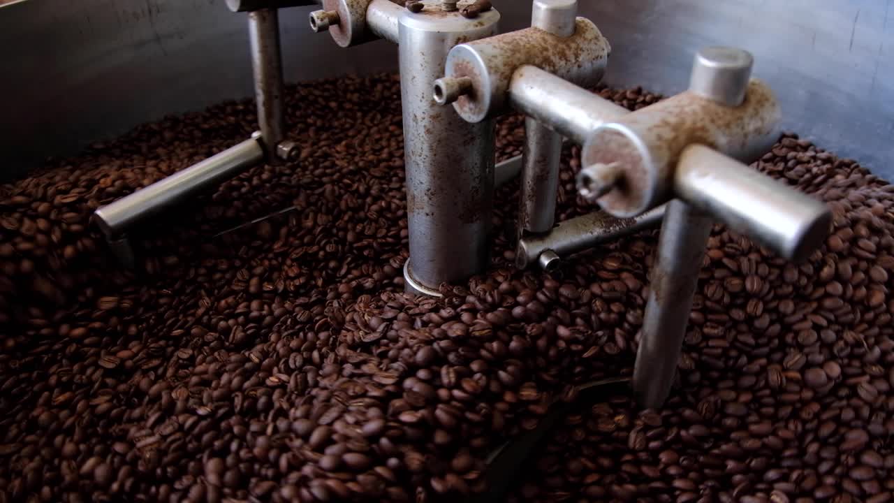 Industrial coffee roaster machine with stainless steel components turning and cooling freshly roasted coffee beans