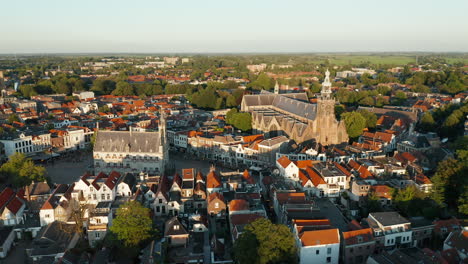 panoramic view of the saint-john church and old town hall amidst the cityscape of gouda