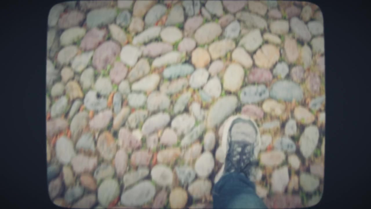 POV feet walking on ancient pavement