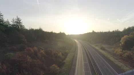 steady shot of sunset or sunrise at an overpass and highway