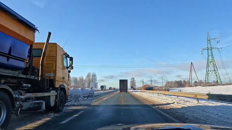 snow plow pushing snow off the road with a pov view of the road ahead