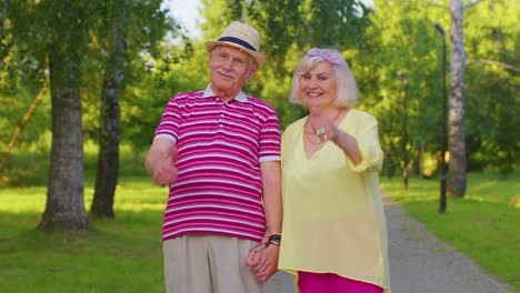 senior couple grandmother grandfather raises thumbs up like, agrees with something, positive reply