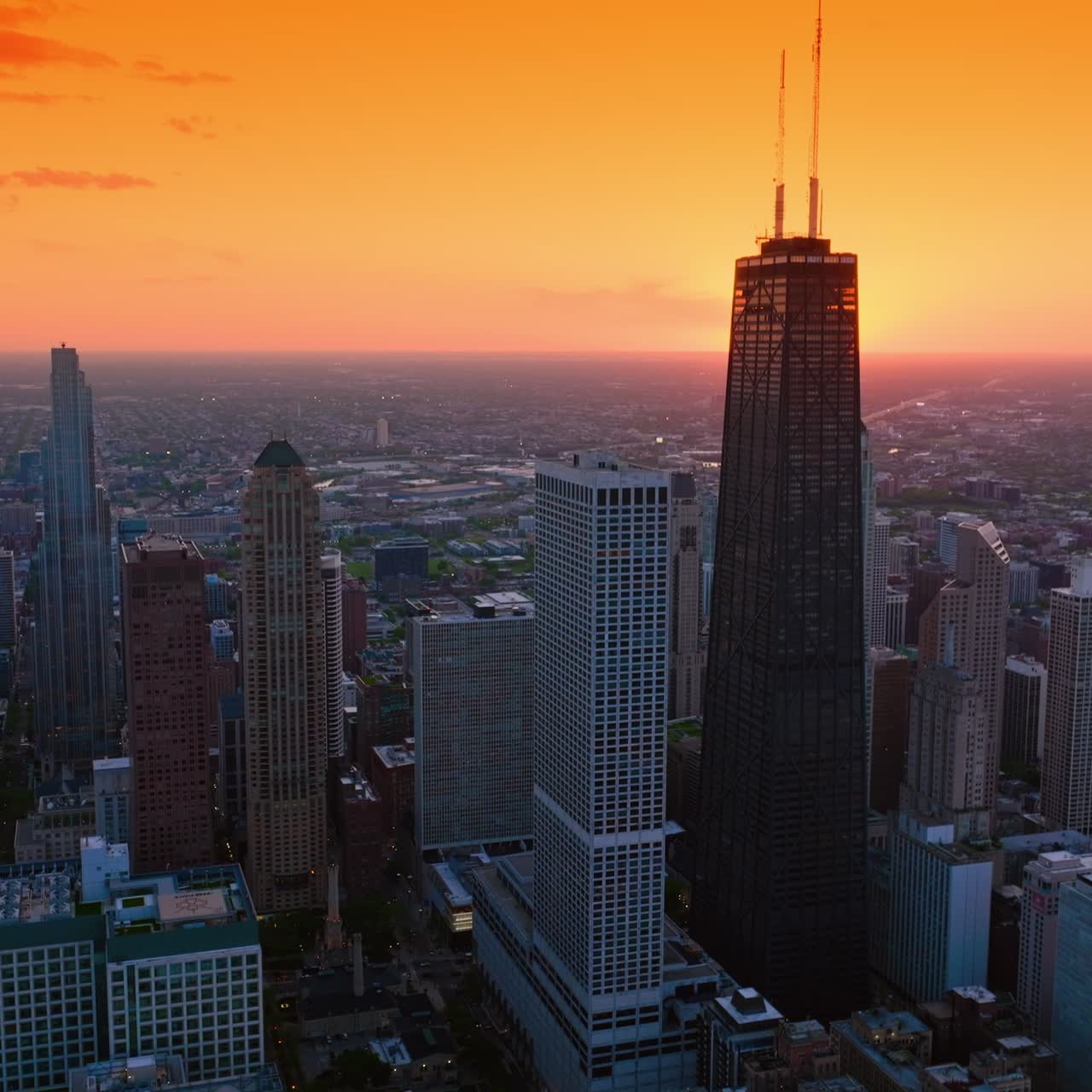 Splendid scenery of vast Chicago at setting sun. Metropolis skyline against orange skies backdrop