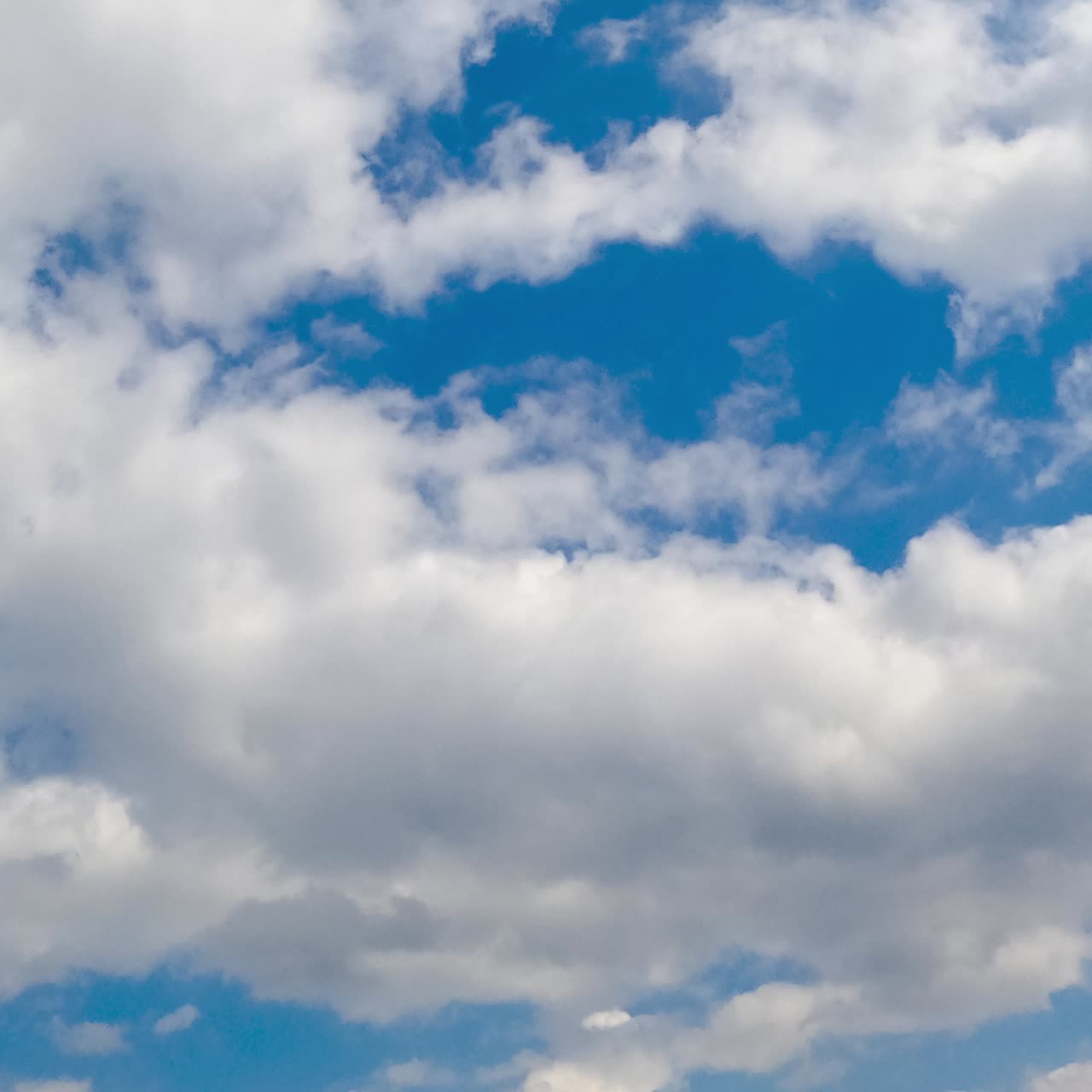 Light soft white clouds in the atmosphere. Quick cloudscape formation from low angle view. Timelapse