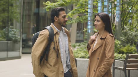 muslim couple on date talking together on city street