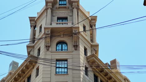 Establishing-the-Ariztía-Building-first-skyscraper-in-Santiago,-Chile-with-cables-hanging-on-New-York-Street