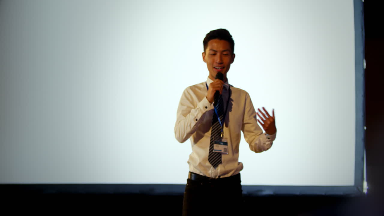 joven empresario asiático hablando en un seminario de negocios en el auditorio 4k