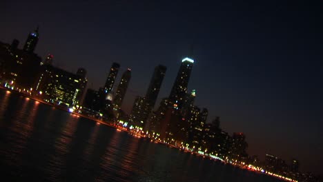 a sweeping angled view of chicago at night from the lakefront