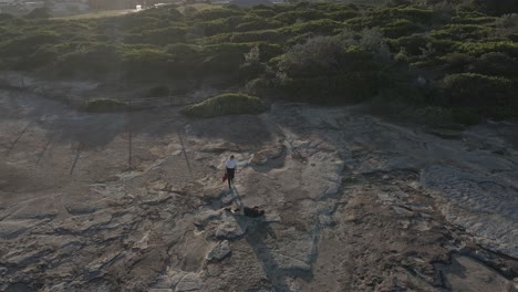 female medical worker coming to rescue an injured tourist - accident in clovelly cliff, sydney - high angle, static shot