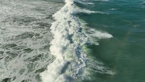 seascape with rolling huge foamy waves in carballo, a coruña, spain - drone shot