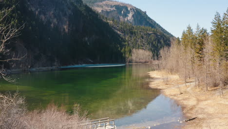 Aerial-fly-over-beautiful-lake-with-small-bridge-and-a-flooded-footpath