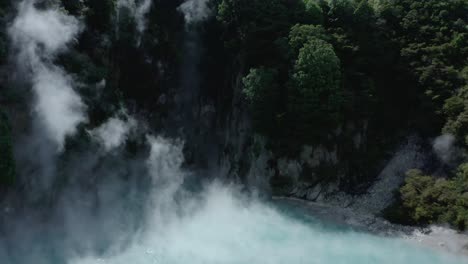 rising from blue inferno crater over lush hill to reveal lake rotomahana