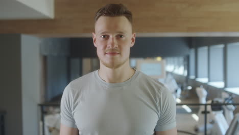 portrait of male fitness instructor in gym