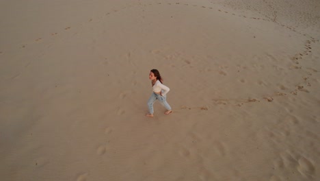 Young-attractive-woman-walking-on-the-beach-in-Spain