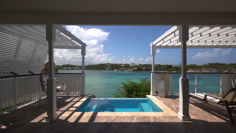 pov shot walking over a luxury villa terrace with a pool, sunny day in antigua