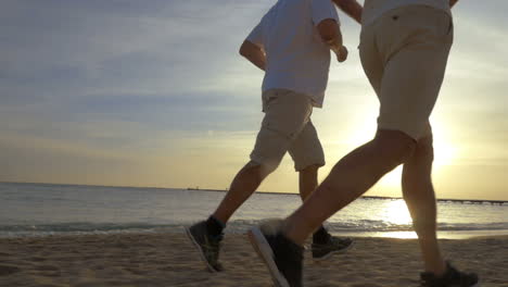 two men jogging on the beach