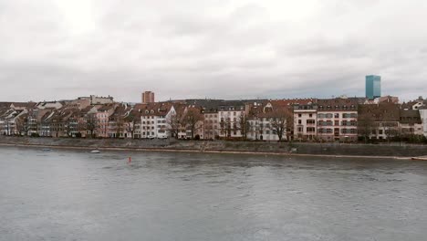 rhine river against riverside basel cityscape, switzerland