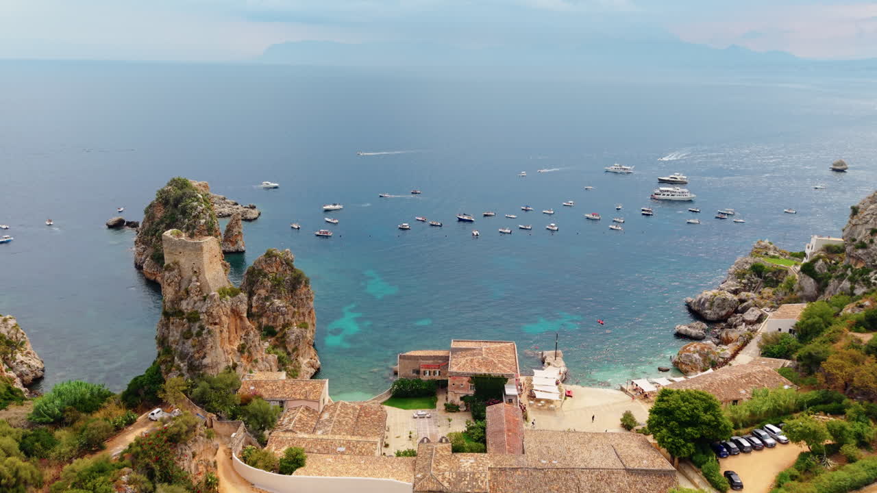 Many ships docked in the seashore of Scopello, Sicilian coast. Aerial