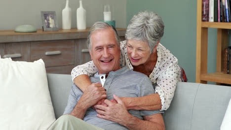 Senior-couple-embracing-in-living-room