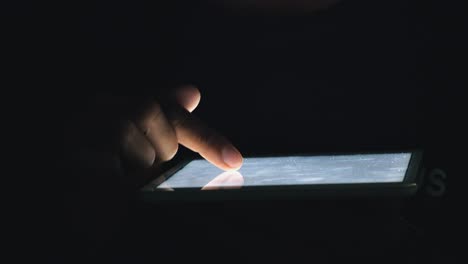 Medium-Shot-of-Somebody-Using-a-Tablet-at-Night