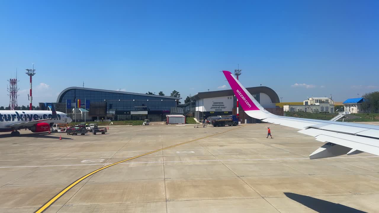 Plane window view takeoff Suceava Airport in Romania, fly airplane wing view