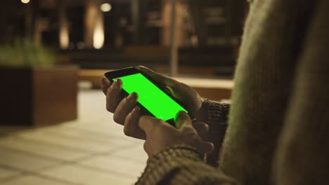 mans hand using green mockup screen smartphone